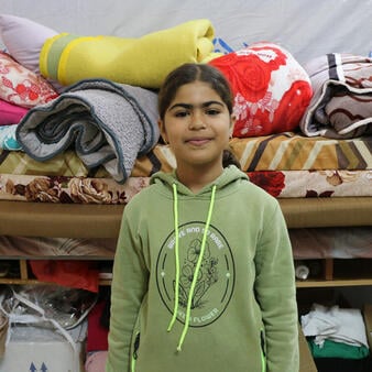 Portrait of Lourine, 9, who had to flee her home in Lebanon.